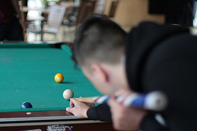 Ein Teilnehmer spielt Billard.